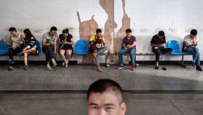 Chineses esperam em um centro de busca de emprego.