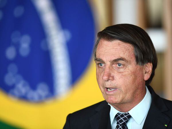 Brazilian President Jair Bolsonaro delivers a speech after holding a meeting with US National Security Advisor Robert O'Brien at Itamaraty Palace in Brasilia, on October 20, 2020. - The United States and Brazil signed three agreements Monday they said would expand and deepen their existing trade deal, the latest bonding moment under Presidents Donald Trump and Jair Bolsonaro. The new protocol adds chapters on facilitating trade, regulatory practices and anti-corruption measures. (Photo by EVARISTO SA / AFP)