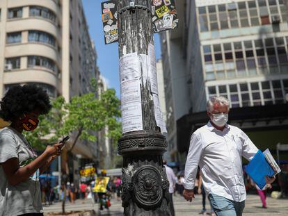 Mulher anota em seu telefone uma oportunidade de emprego a partir de listas postadas em um poste de luz no centro de São Paulo no final de setembro.