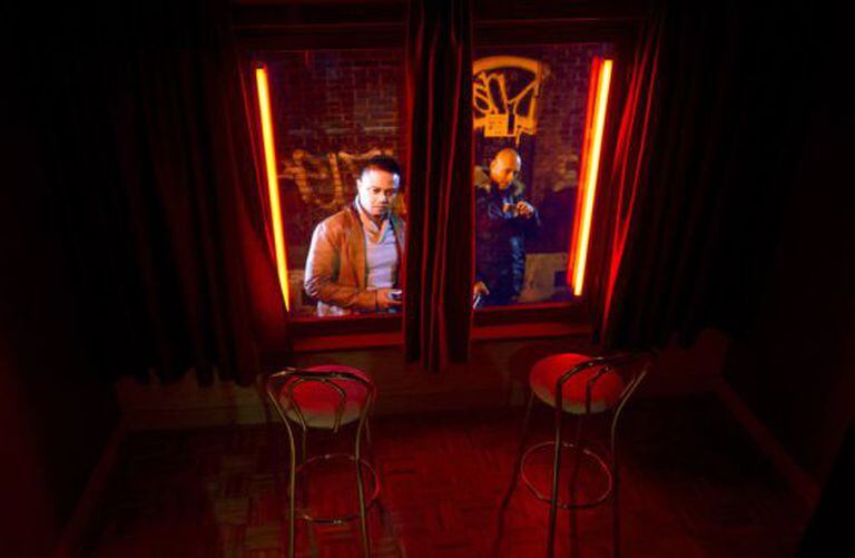 Dois homens vistos desde o interior do museu Rede Light District.