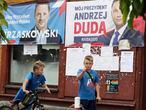 In this Thursday, July 9, 2020 photo election campaign posters of incumbent conservative president, Andrzej Duda, right, and his challenger, the liberal Warsaw mayor Rafal Trzaskowski, for a tight presidential election runoff on Sunday, July 12, 2020 are seen in Raciaz, Poland. (AP Photo/Czarek Sokolowski)