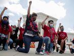 DACA recipients and their supporters kneel in support of the Black Lives Matter movement, chanting "Say their Names" and the names of Breonna Taylor and George Floyd, as they celebrate outside the U.S. Supreme Court after the court ruled in a 5-4 vote that U.S. President Donald Trump's 2017 move to rescind the Deferred Action for Childhood Arrivals (DACA) program, created in 2012 by his Democratic predecessor Barack Obama, was unlawful, in Washington, U.S. June 18, 2020.   REUTERS/Jonathan Ernst