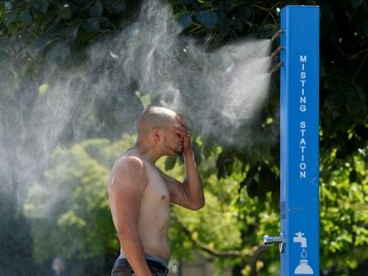 Um homem se refresca numa praça de Vancouver, na costa canadense do Pacífico, neste domingo.