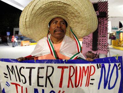 Martin Macias segura cartaz contra Trump em Ciudad Juarez, no M&eacute;xico.