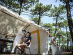 A medical staff collects a nasal swab from a man at a COVID-19 (novel coronavirus) free screening tent set up in the parking lot of the Petit Nice beach in La Teste-de-Buch, southwestern France, on July 24, 2020. (Photo by Philippe LOPEZ / AFP)