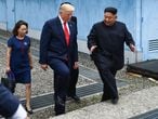 North Korea's leader Kim Jong Un and US President Donald Trump walk together south of the Military Demarcation Line that divides North and South Korea, after Trump briefly stepped over to the northern side, in the Joint Security Area (JSA) of Panmunjom in the Demilitarized zone (DMZ) on June 30, 2019. (Photo by Brendan Smialowski / AFP)