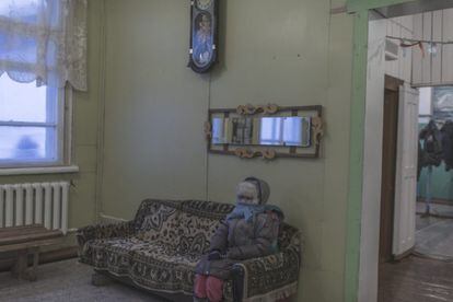 Uma moradora espera sentada dentro de um escritório em Oymyakon.