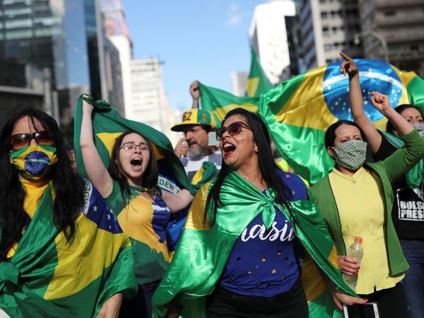 Supporters of far-right Brazilian President Jair Bolsonaro take part in a motorcade to protest against social distancing and quarantine measures, recommended by Sao Paulo's governor Joao Doria, following the coronavirus disease (COVID-19) outbreak, in Sao Paulo, Brazil, May 3, 2020. REUTERS/Amanda Perobelli