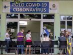 People with COVID-19 symptoms wait to be assisted outside a hospital that is at full capacity in Ribeirao Preto, Sao Paulo state, Brazil, Friday, May 28, 2021. The city imposed strict shutdown measures this week to stop the spread of the virus, halting public transportation for the first time and closing supermarkets. (AP Photo/Andre Penner)