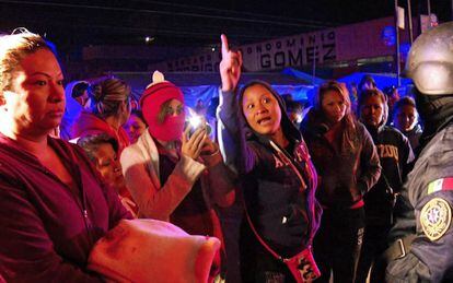 Family members of inmates stand outside Topo Chico prison following the riot.