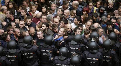 Agentes anti distúrbios da Polícia Nacional isolam catalães.