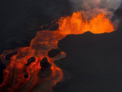 FILE - In this June 10, 2018 photo, lava from the Kilauea volcano continues to erupt from a fissure and forms a river of lava flowing down to Kapoho in Pahoa, Hawaii. (AP Photo/L.E. Baskow, File)