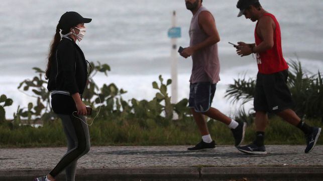 People walk at Recreio dos Bandeirantes beach, amid the coronavirus disease (COVID-19) outbreak, in Rio de Janeiro, Brazil April 4, 2020. REUTERS/Sergio Moraes