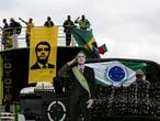 A life-size cutout of Brazil's President Jair Bolsonaro is attached to an army truck replica, during a protest against former Justice Minister Sergio Moro and the Supreme Court, in front of the National Congress in Brasilia, Brazil, Saturday, May 9, 2020. (AP Photo/Eraldo Peres)
