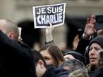 FILE PHOTO: A person holds up a "Je Suis Charlie" (I am Charlie) sign during a ceremony at Place de la Republique to pay tribute to the victims of last year's shooting at the French satirical newspaper Charlie Hebdo, in Paris, France, January 10, 2016. REUTERS/Yoan Valat/Pool/File Photo
