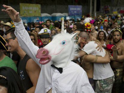 Folião se fantasia de unicórnio em bloco do Rio neste sábado.