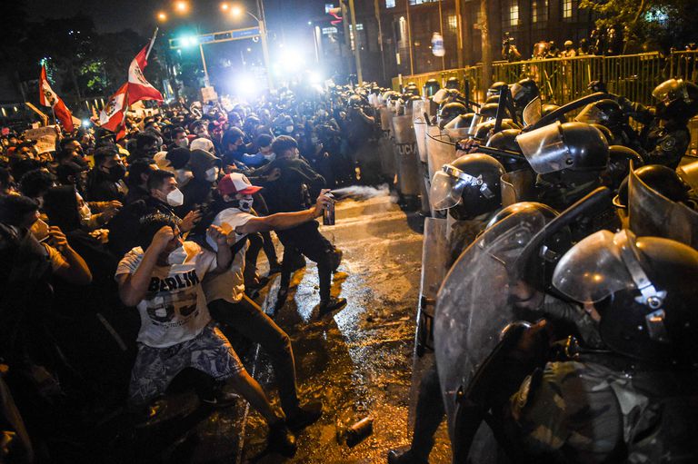 Manifestantes enfrentam a polícia nos protestos em Lima, na noite de quinta-feira.