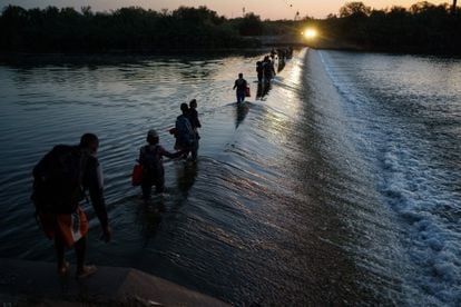 Um grupo de migrantes haitianos atravessa o rio Grande para obter alimentos e suprimentos perto do passo fronteiriço Del Río-Acuña, em Ciudad Acuña, Estado de Coahuila, México.