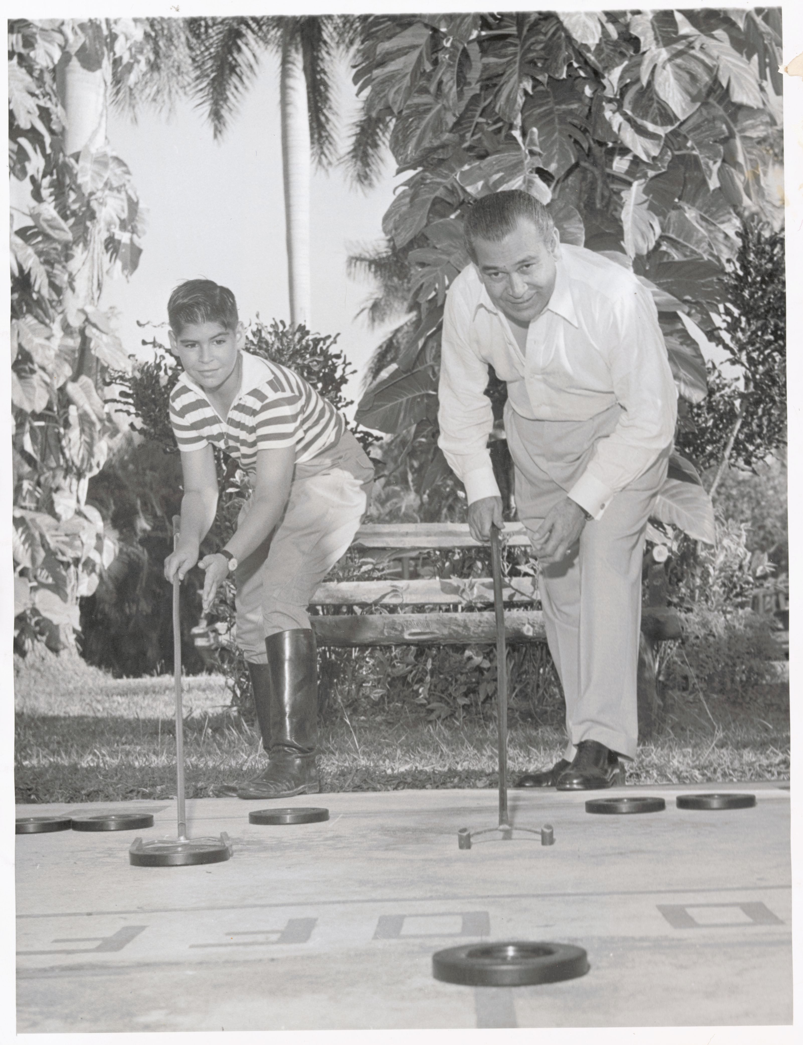Roberto Batista joga ‘shuffleboard’ com seu pai na propriedade familiar em Havana, em 1958. 
