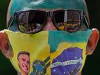 A supporter of Brazilian President Jair Bolsonaro wears a face mask, due to the COVID-19 pandemic, decorated with a photo of Bolsonaro at a rally marking Independence Day in Sao Paulo, Brazil, Tuesday, Sept. 7, 2021. (AP Photo/Andre Penner)