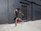 Afro american woman with dreadlocks in a great athletic shape working out and training hard outdoors