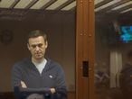 This handout picture provided by the Babushkinsky district court on February 12, 2021, shows Russian opposition leader Alexei Navalny, charged with defaming a World War II veteran, standing inside a glass cell during a court hearing in Moscow. (Photo by Handout / Moscow's Babushkinsky district court press service / AFP) / RESTRICTED TO EDITORIAL USE - MANDATORY CREDIT "AFP PHOTO / Moscow's Babushkinsky district court press service / handout " - NO MARKETING - NO ADVERTISING CAMPAIGNS - DISTRIBUTED AS A SERVICE TO CLIENTS