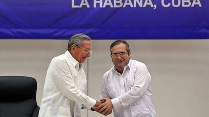 O líder das FARC, Rodrigo Londoño Echeverri, alias "Timochenko" (d), estreita a mão do presidente de Cuba, Raúl Castro.