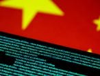 FILE PHOTO: Computer code is seen on a screen above a Chinese flag in this July 12, 2017 illustration photo.   REUTERS/Thomas White/Illustration/File Photo/File Photo