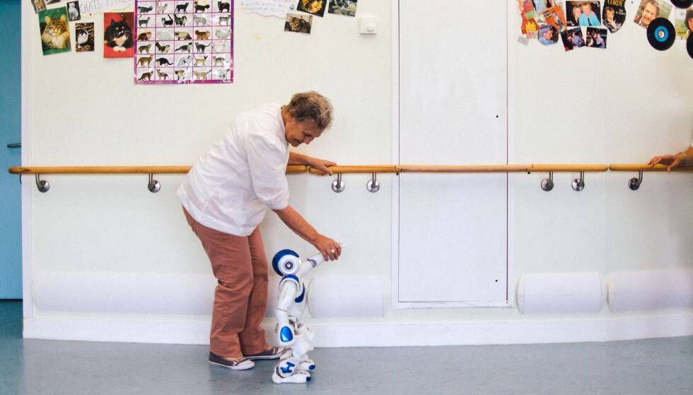 O robô ajuda uma paciente em reabilitação a caminhar.