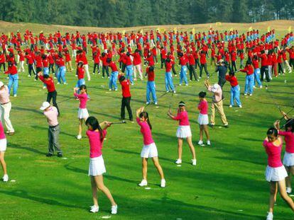 Centenas de jogadores treinam golfe em Hainan (China).