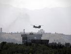A U.S. Chinook helicopter flies over the U.S. Embassy in Kabul, Afghanistan, Sunday, Aug. 15, 2021. Helicopters are landing at the U.S. Embassy in Kabul as diplomatic vehicles leave the compound amid the Taliban advanced on the Afghan capital. (AP Photo/Rahmat Gul)