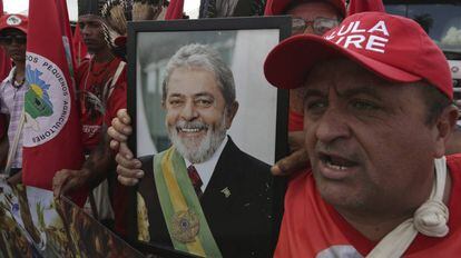 Militante do MST segura foto de Lula em protesto nesta quarta-feira, em Brasília.