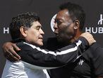 (FILES) In this file photo taken on June 09, 2016 former Argentinian football international Diego Maradona (L) and former Brazilian footballer Pele pose after a football match organised by Swiss luxury watchmaker Hublot at the Jardin du Palais Royal in Paris, on the eve of the Euro 2016 European football championships. - Argentinian football legend Diego Maradona passed away on November 25, 2020. (Photo by PATRICK KOVARIK / AFP)