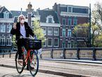 AMSTERDAM, NETHERLANDS - 2020/04/16: A man rides a bicycle while wearing a face mask as a preventive measure against the spread of corona virus.
Wearing face masks has become popular because its one of the most applied preventive measure against the covid-19 pandemic. (Photo by Robin Utrecht/SOPA Images/LightRocket via Getty Images)