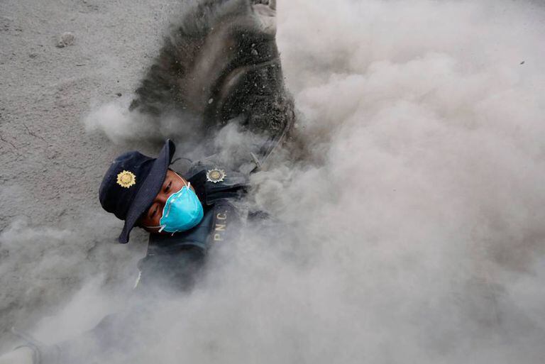 Policial tropeça e cai enquanto fugia da erupção do fluxo piroclástico provocado pela erupção do Vulcão de Fogo na Guatemala, na comunidade de San Miguel Los Lotes em Escuintla.