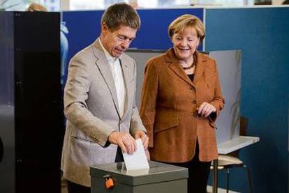 Angela Merkel vê seu marido, Joachim Sauer, depositar seu voto nas eleições que deram a ela seu terceiro mandato como chanceler da Alemanha.