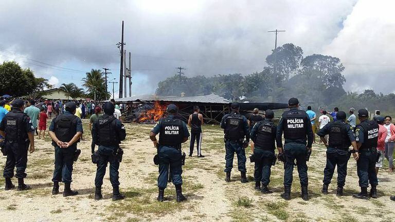 Policiais vigiam o local onde manifestantes queimaram acampamento em que dormiam imigrantes venezuelanos em Paracaima (Roraima).
