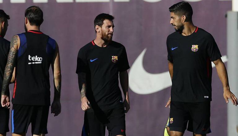 Messi conversa com Luis Suárez no treino do Barça.