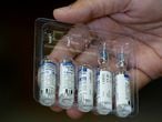 FILE PHOTO: A paramedic holds a pack of used and unused vials of Russia's Sputnik V coronavirus disease (COVID-19) vaccine at a private hospital in Karachi, Pakistan April 4, 2021. REUTERS/Akhtar Soomro/File Photo