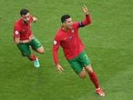 Portugal's forward Cristiano Ronaldo (R) celebrates scoring their first goal with Portugal's midfielder Bruno Fernandes (L) during the UEFA EURO 2020 Group F football match between Portugal and Germany at Allianz Arena in Munich on June 19, 2021. (Photo by Matthias Hangst / POOL / AFP)