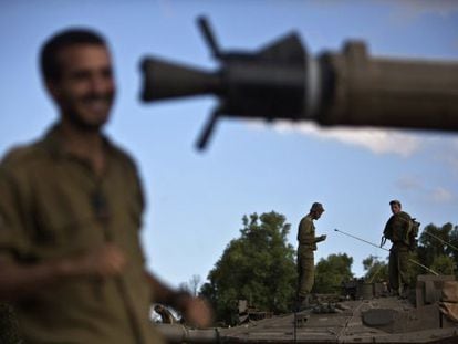 Soldados israelenses sobre um tanque na fronteira com Gaza.