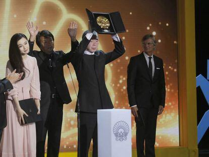 O diretor Xiaogang Feng levanta a Concha de Ouro, acompanhado de sua equipe e da atriz Fan Bingbing em San Sebastián (Espanha).