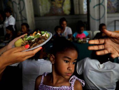 Voluntários distribuem refeições em Caracas, em maio de 2018