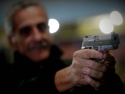 Homem segura pistola da Taurus em São Paulo.
