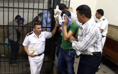 Os acusados escondem o rosto após a condenação no Cairo.