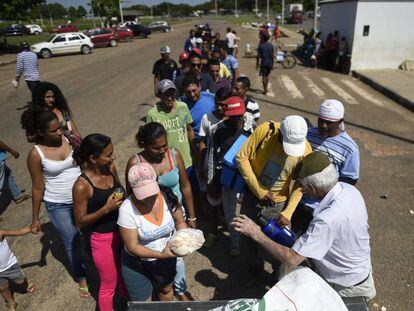 Brasileiro distribui pães a refugiados venezuelanos.