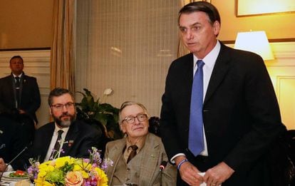 Jair Bolsonaro discursa ao lado do ideólogo de extrema direita Olavo de Carvalho e do chanceler Ernesto Araújo.