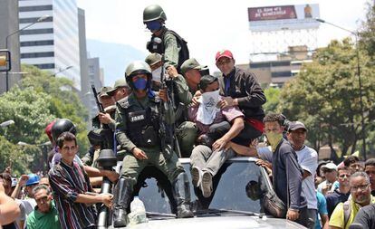 Soldados, com seguidores de Juan Guaidó nesta terça-feira