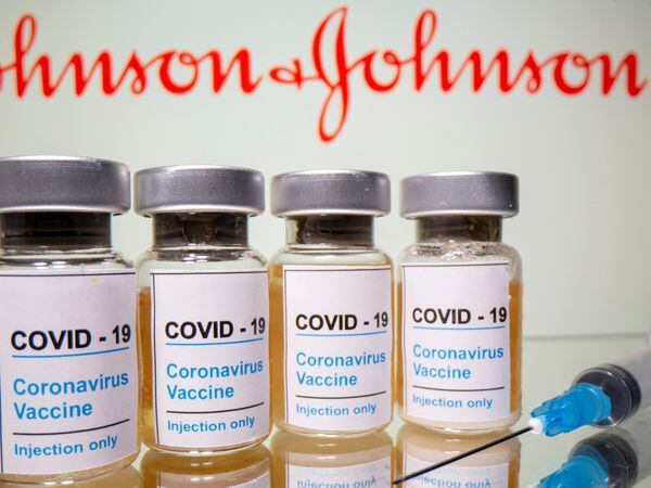 FILE PHOTO: Vials with a sticker reading, "COVID-19 / Coronavirus vaccine / Injection only" and a medical syringe are seen in front of a displayed Johnson & Johnson logo in this illustration taken October 31, 2020. REUTERS/Dado Ruvic/Illustration/File Photo