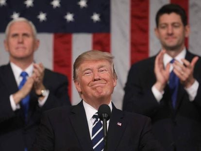 O presidente Trump sorri na presença do seu vice, Mike Pence, e do presidente da Câmara de Deputados, Paul Ryan.